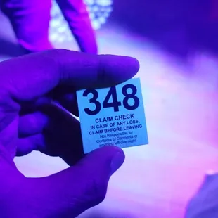 a person holding a purple ticket
