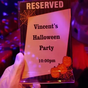 a sign for a halloween party