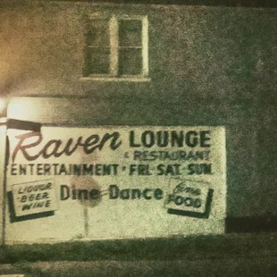 a sign for raven lounge