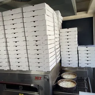 stacked pizza boxes on a conveyor belt