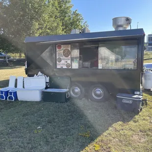 a food truck parked in a field