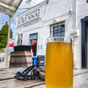 a glass of beer on a picnic table