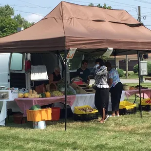 eople standing under a tent