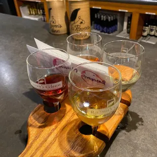 three glasses of wine on a cutting board