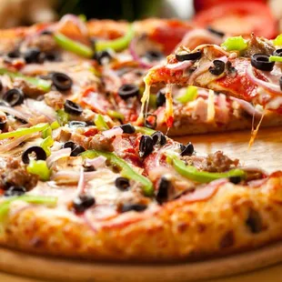 a pizza with olives and peppers