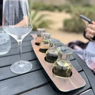 a table with a wine glass and a tray of oysters