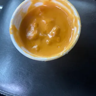 Spoiled clumpy disgusting cheese sauce.