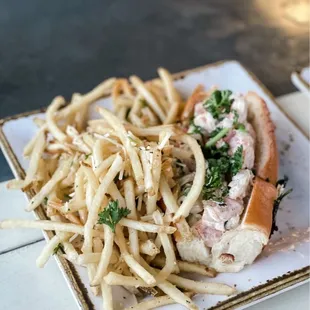 Shrimp salad on toasted brioche bun with truffle parm fries