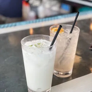 two cocktails on a bar