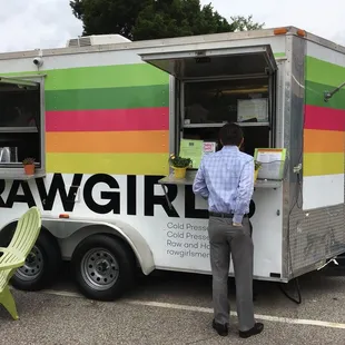 a man standing in front of a food truck