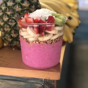 a fruit smoothie and a pineapple