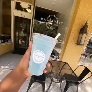 a hand holding a blue monster