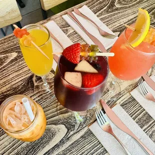 Refreshment (left to right) Thai iced tea, Mango Mimosa, Red Sangria, Watermelon Sangria