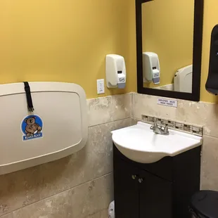Clean bathroom includes changing station.