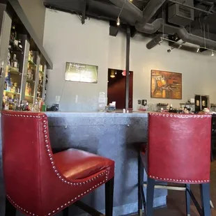 a bar with red leather chairs