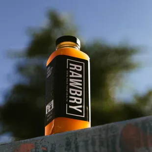 a bottle of drink sitting on a ledge