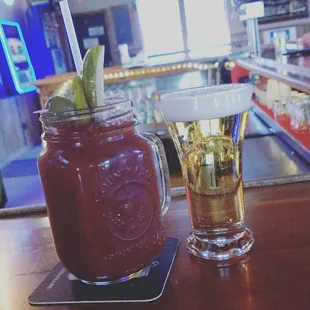 a glass of beer and a jar of pickles