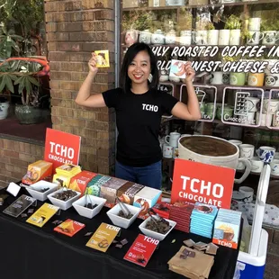 a woman standing in front of a table