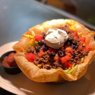 a taco salad with sour cream
