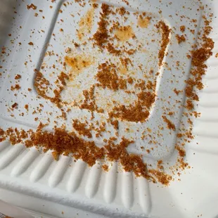 a half eaten donut in a styrofoam container