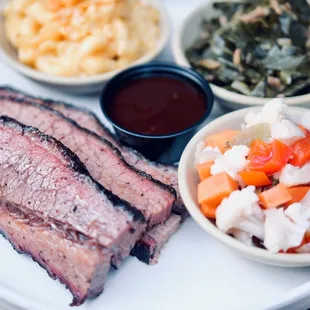 a plate of meat and sides
