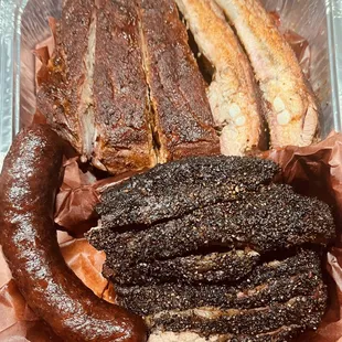 Our takeout: 2lbs Brisket (lean/fatty by request), 2 half-rack Memphis style ribs. House made sausage. Bomb!