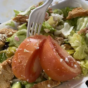 a salad in a styrofoam container