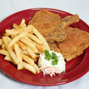 a red plate with fries and coleslaw