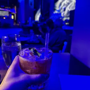 a hand holding a drink