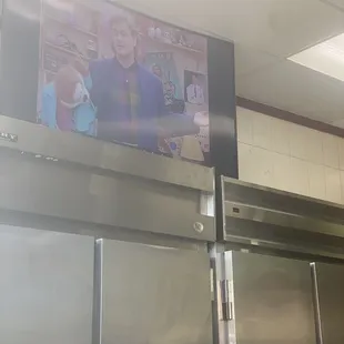 TV atop fridge at left for viewing while waiting.
