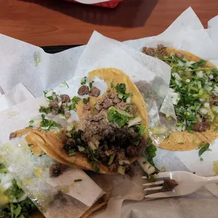 3 steak tacos with cilantro and onions on corn tortillas.  Very good quality  and plentiful