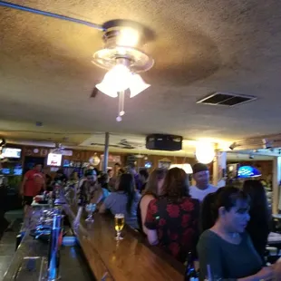 a crowd of people sitting at a bar