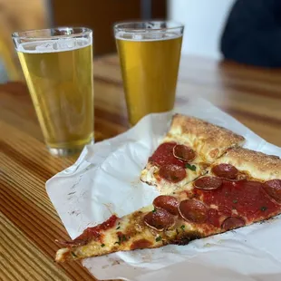 a slice of pepperoni pizza and a glass of beer