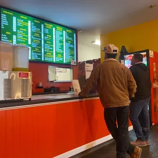 two men standing at the counter