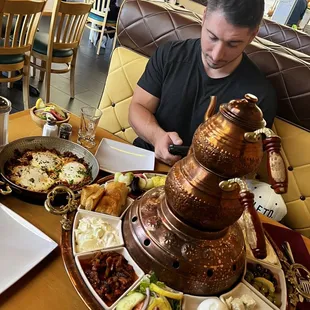 a man sitting at a table with food