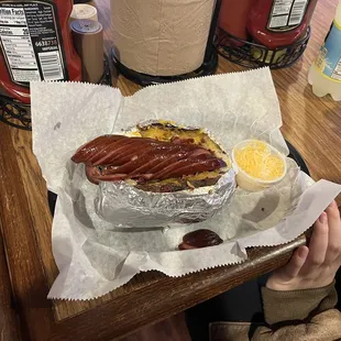 Baked potato with bacon and sausage