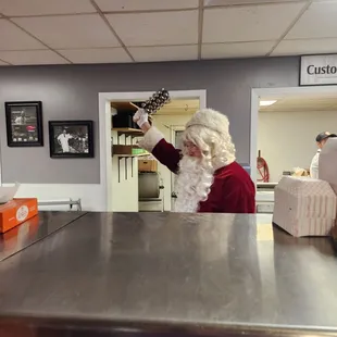 Santa made everyone sing while waiting to pick up Christmas dinner orders.