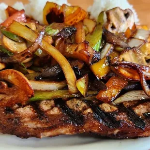 New York steak with mushrooms, onions, and bell peppers.