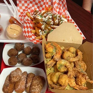 Loaded shrimp fries, garlic shrimp noodles, Jalapenos with Cheese poppers and Hush Puppies