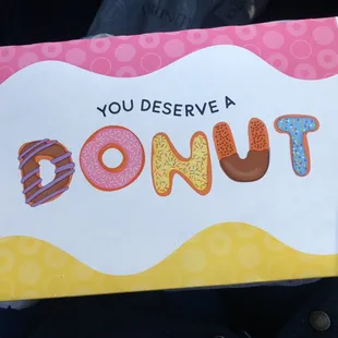 Top of donut box that says you deserve a donut