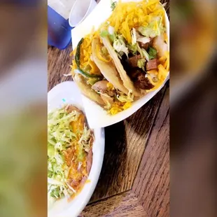 a plate of tacos and a bowl of rice
