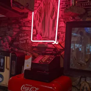 a coca cola machine with a neon sign