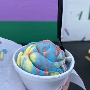 a person holding a bowl of ice cream