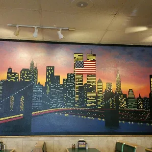 A wall painted to look like New York skyline with the Twin Towers still depicted. Painted prior to 9-11.