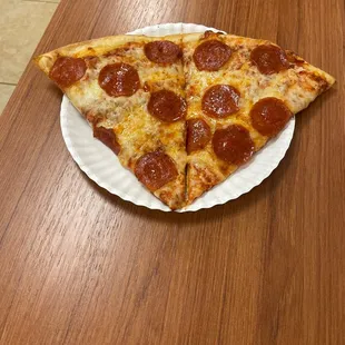 a slice of pepperoni pizza on a paper plate