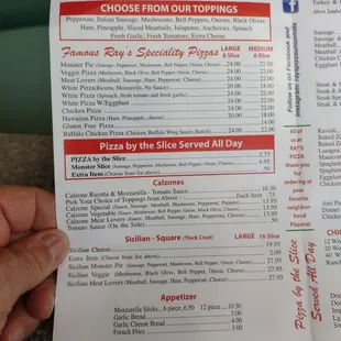 a hand holding a menu