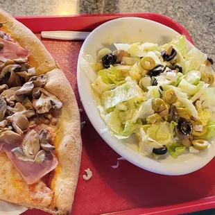 Pizza slices with ham and mushrooms. Dinner salad with Italian dressing.