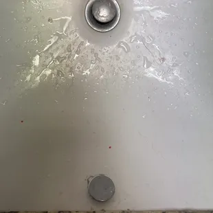 a dirty sink with a drain
