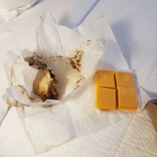 a banana and cheese on a bed