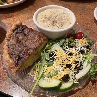 a plate of food with a salad and a quiche